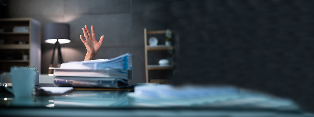 Picture of a hand above a stack of papers